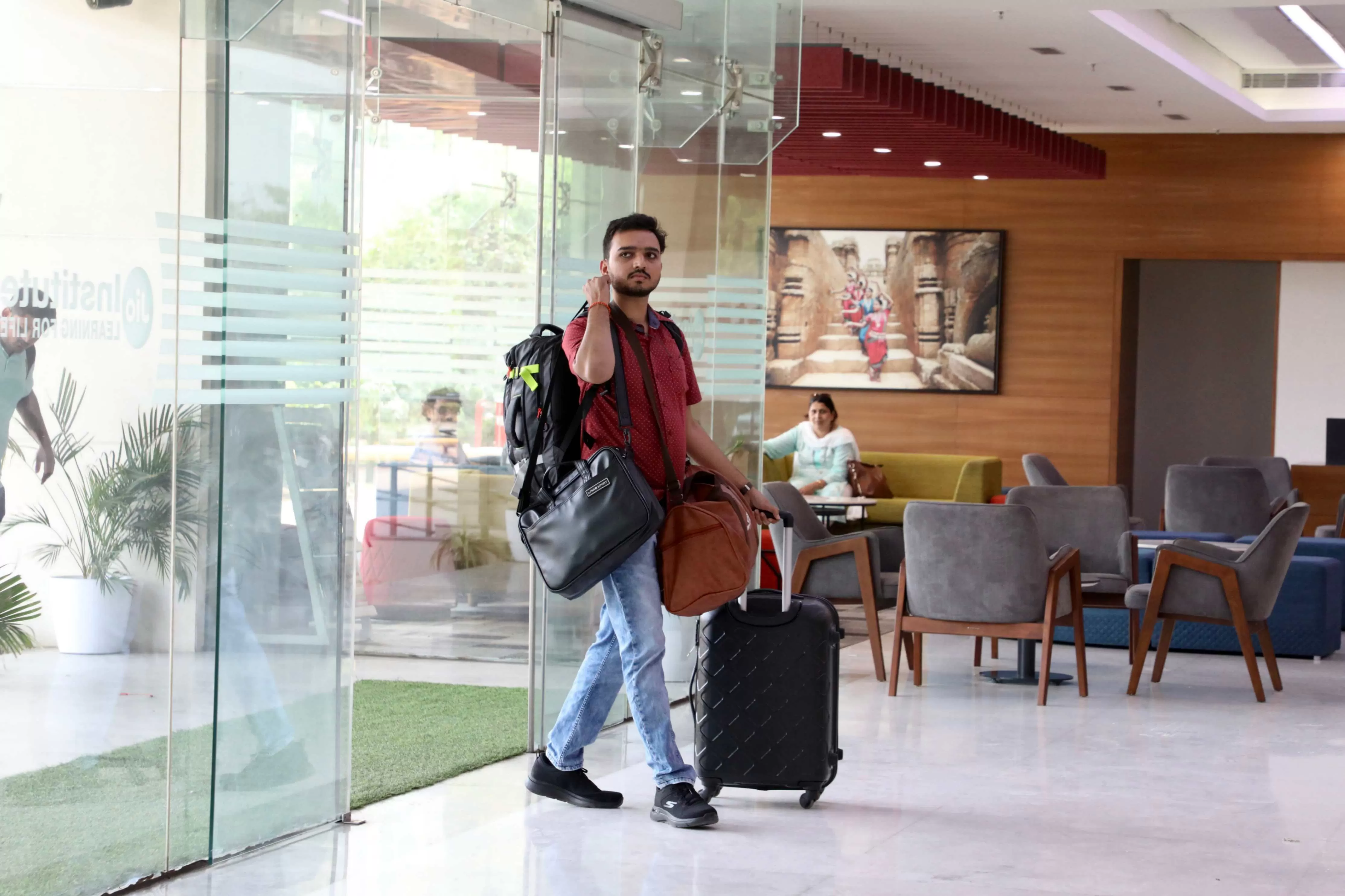 student entering campus with bags