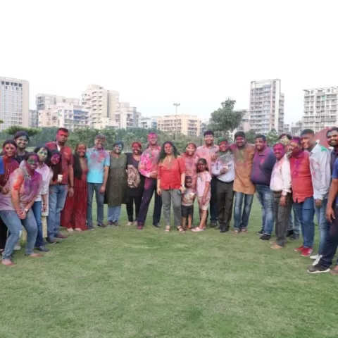 Students and staff pose after Holi celebrations