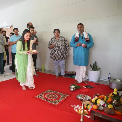 A student doing aarti at the Puja Ceremony