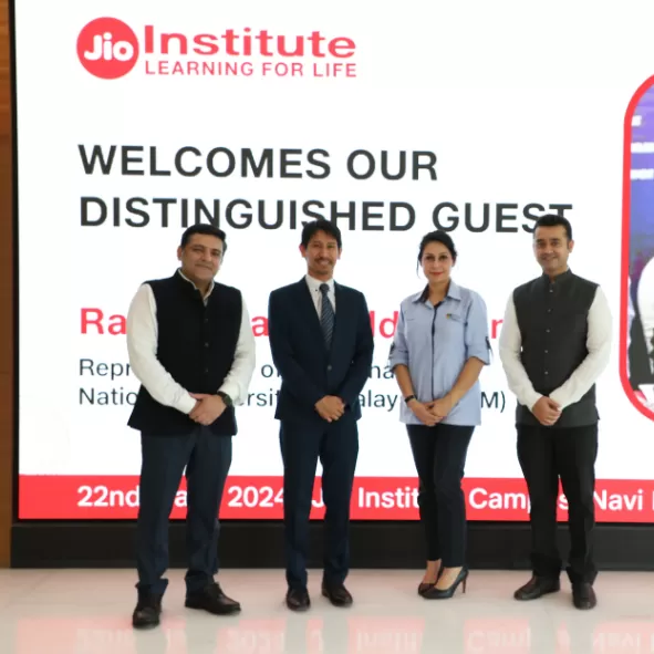 Staff and the guest pose for a photo