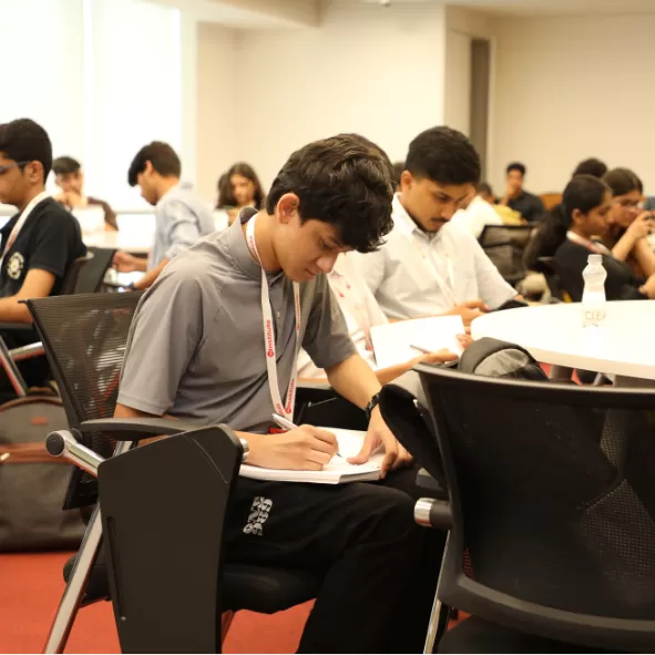 Student listening and taking notes