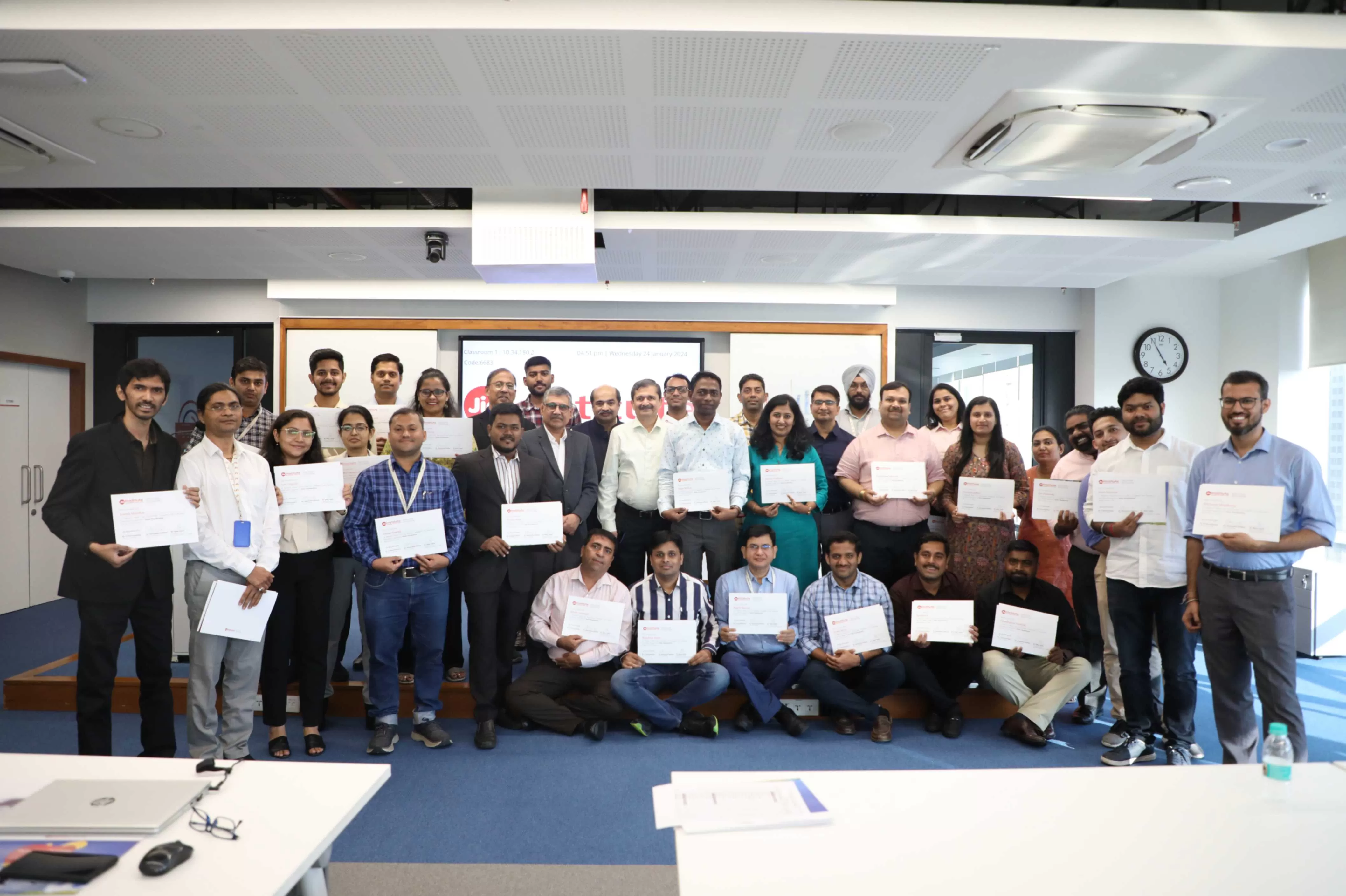Participants and organizers posing after certification